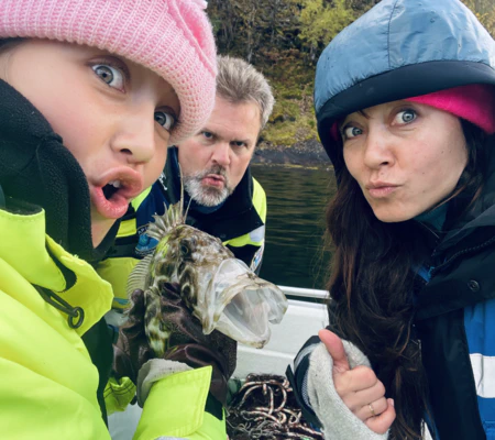 Mother and daughter and funny fish, on viking fishing adventure in sognefjord with captain Tor