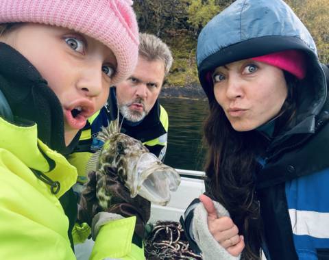 Mother and daughter and funny fish, on viking fishing adventure in sognefjord with captain Tor